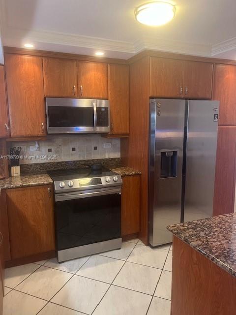800 Northeast 195th Street, Unit 701 Miami, FL 33179 - Photo 4 of 14 a kitchen with granite countertop a refrigerator and a stove top oven