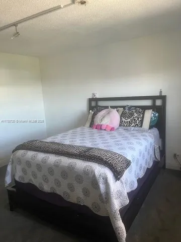 a bedroom with a bed and a night stand