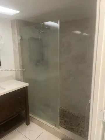 a bathroom with a shower and a sink