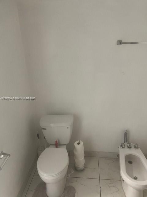 800 Northeast 195th Street, Unit 701 Miami, FL 33179 - Photo 9 of 14 a white toilet sitting next to a white sink