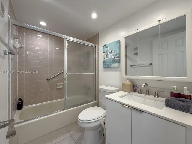 a spacious bedroom with a bed and a flat screen tv