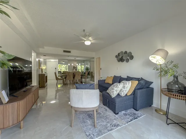a view of a balcony with chairs and potted plants