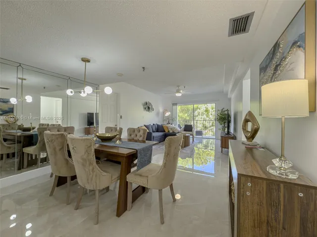 a dining room with furniture a window and a chandelier