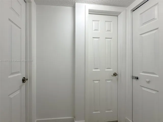 a bedroom with two beds and a flat screen tv