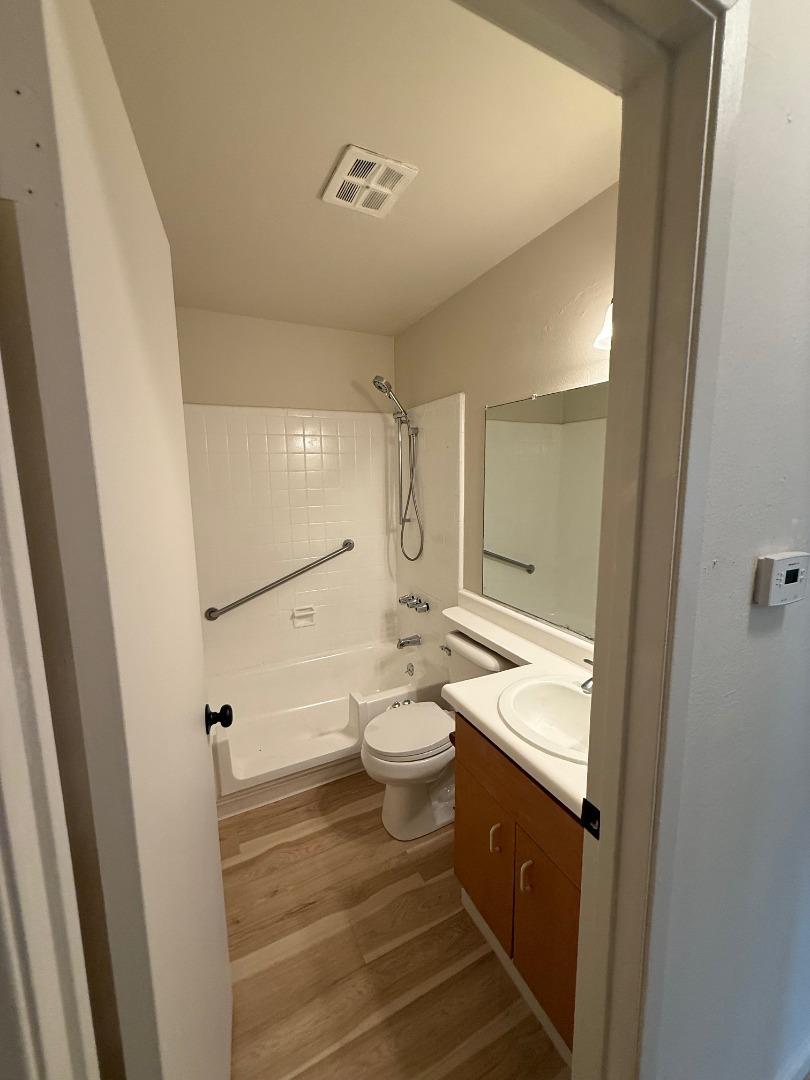 2505 Prescott Road, Unit 1 Modesto, CA 95350 - Photo 31 of 42 a bathroom with a granite countertop sink toilet a mirror and shower