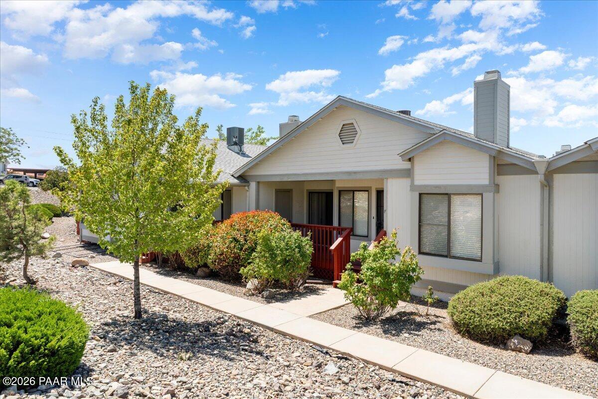 3079 Montana Terrace Road, Unit 12F Prescott, AZ 86301 - Photo 1 of 18 a front view of a house with garden