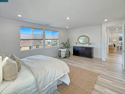 a spacious bedroom with a bed and a couch