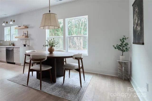 a view of a dining room with furniture window and wooden floor