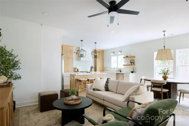 a living room with furniture and a chandelier