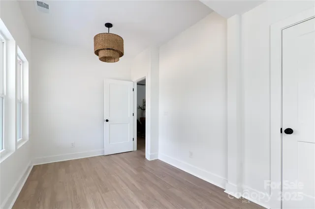 a view of a room with wooden floor and windows