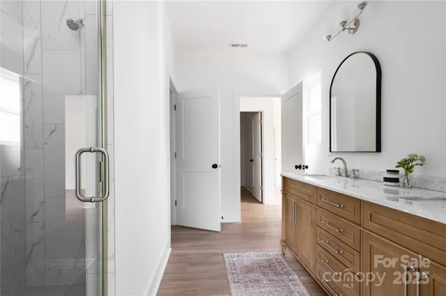 a bathroom with a double vanity sink and mirror