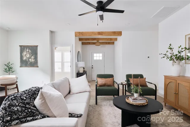 a living room with furniture and a chandelier