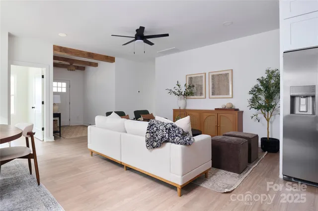 a living room with furniture and a ceiling fan