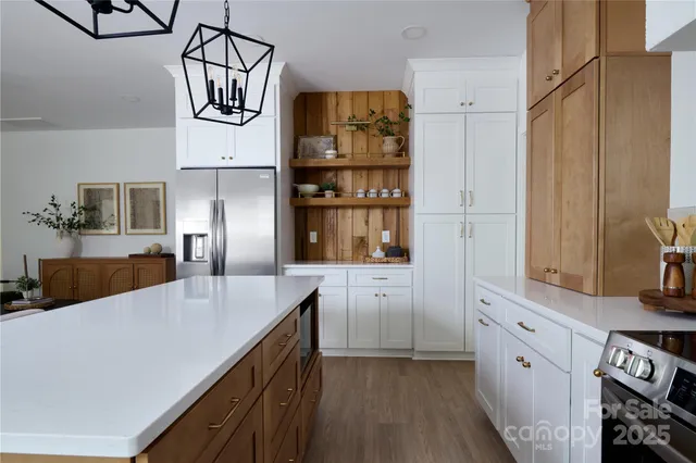 a kitchen with cabinets and wooden floor