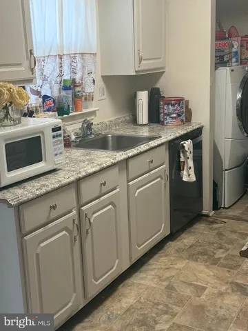 a kitchen with stainless steel appliances granite countertop a sink a stove a refrigerator and cabinets