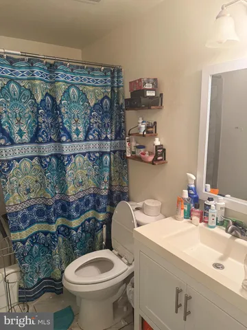 a bathroom with a sink mirror vanity and toilet