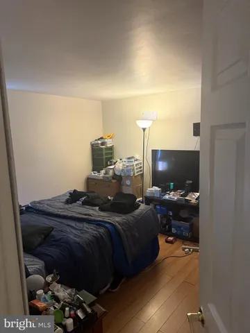 a bedroom with bed and flat screen tv