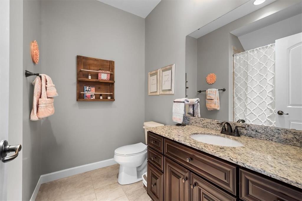 200 Durrow Court Mars, PA 16046 - Photo 30 of 50 a bathroom with a granite countertop sink a toilet and a mirror