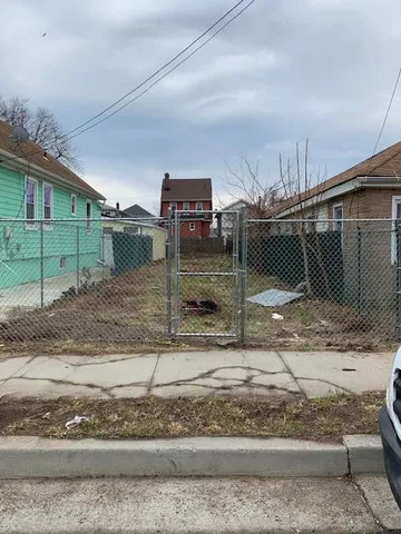 a view of a street with a barn in the background