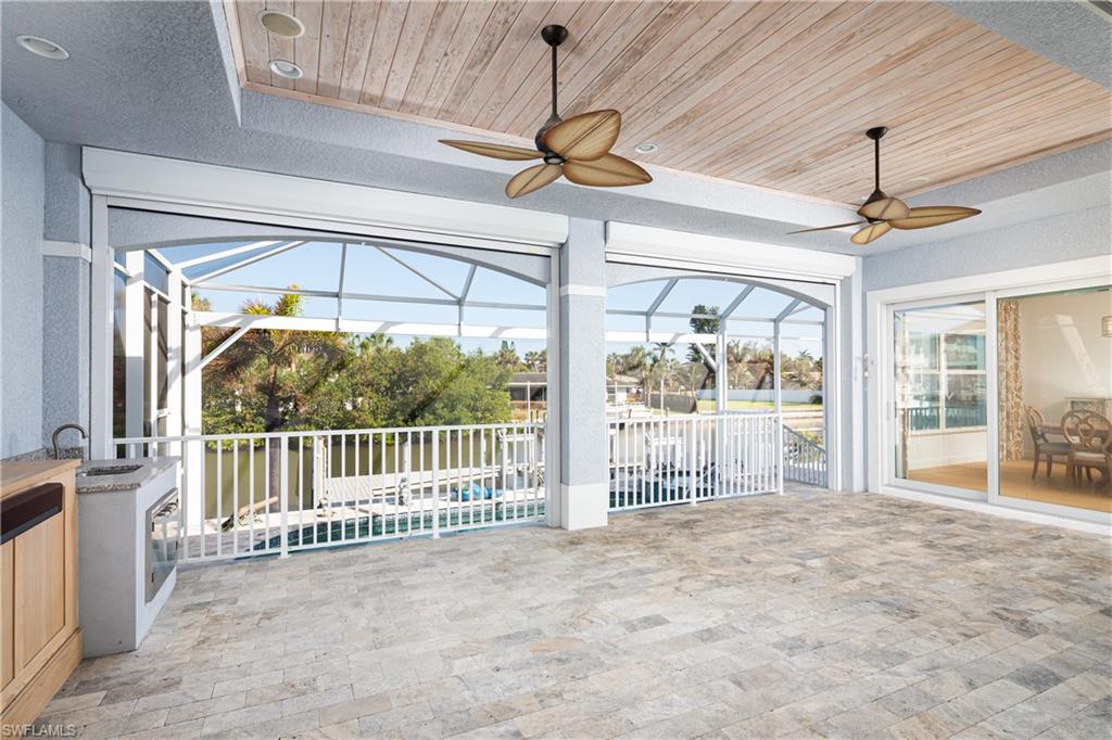 451 Oak Avenue Naples, FL 34108 - Photo 14 of 25 a view of a room with wooden floor and a ceiling fan