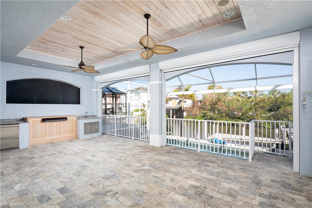 451 Oak Avenue Naples, FL 34108 - Photo 15 of 25 a view of a room with furniture wooden floor and flat screen tv