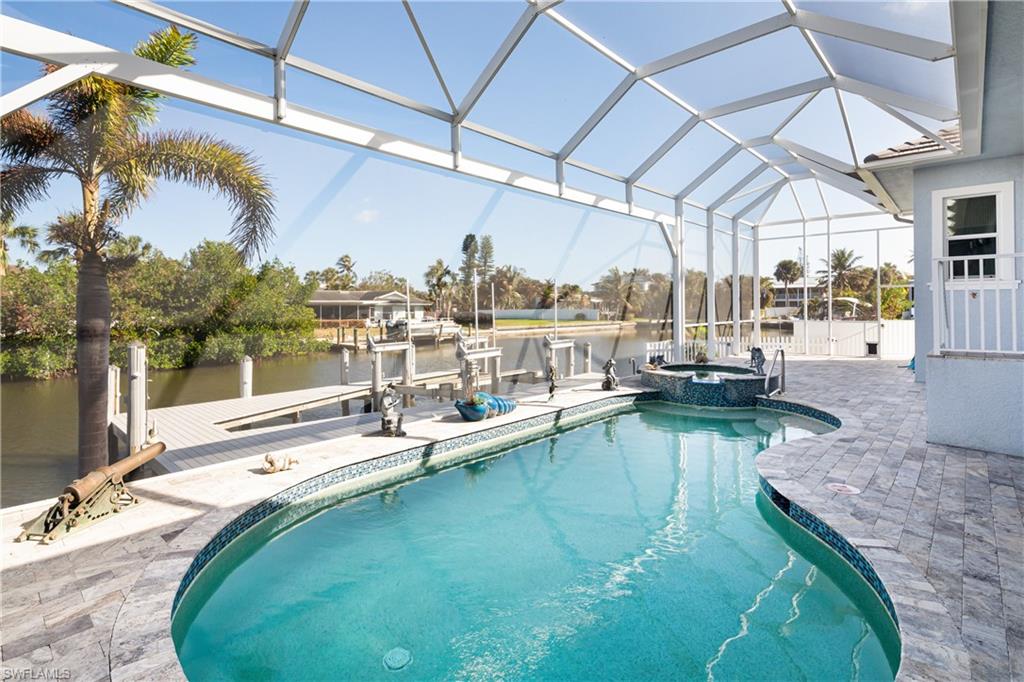 451 Oak Avenue Naples, FL 34108 - Photo 18 of 25 a view of a swimming pool with a patio