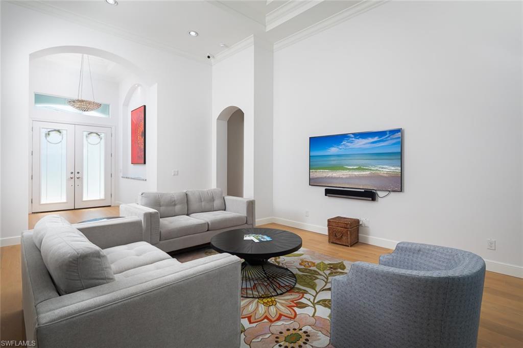 451 Oak Avenue Naples, FL 34108 - Photo 2 of 25 a living room with furniture and a flat screen tv