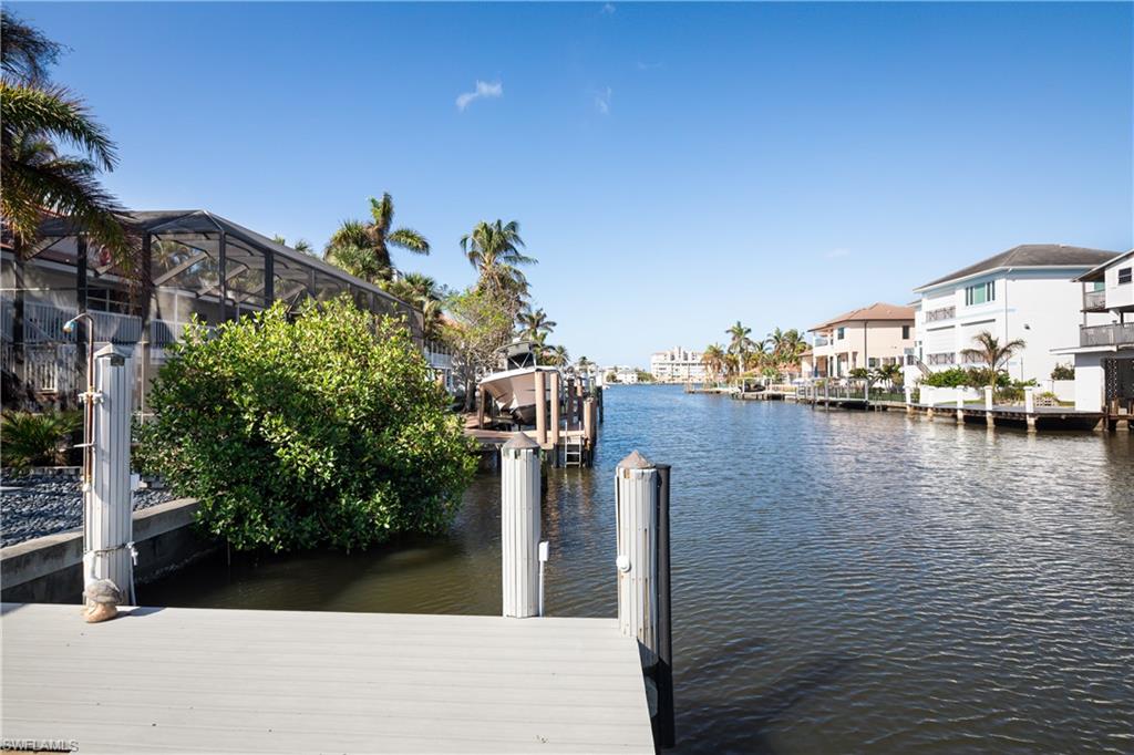 451 Oak Avenue Naples, FL 34108 - Photo 21 of 25 a view of a lake with a building in the background