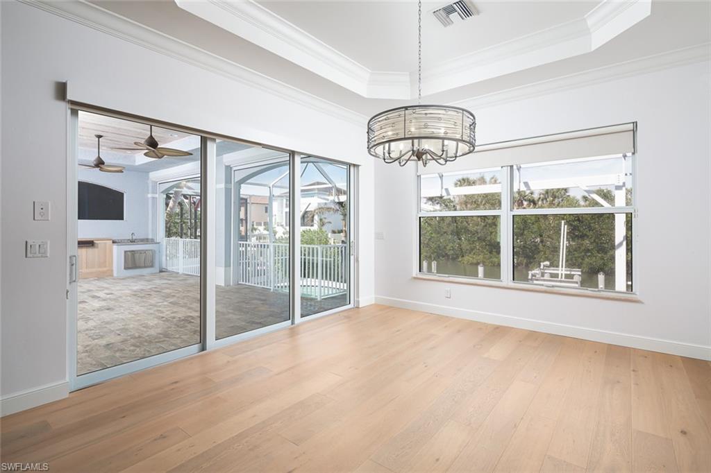 451 Oak Avenue Naples, FL 34108 - Photo 7 of 25 a view of an empty room with wooden floor and a window