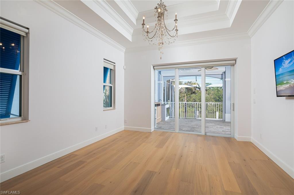 451 Oak Avenue Naples, FL 34108 - Photo 8 of 25 a view of an empty room with wooden floor and a window