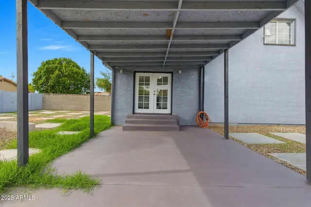 a view of a porch with furniture and garden
