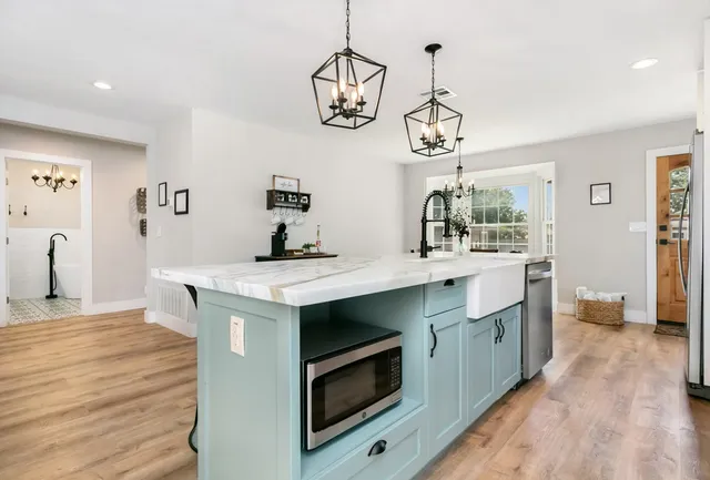 a kitchen with a sink and a stove top oven
