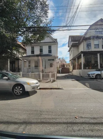 a front view of a building with parking space