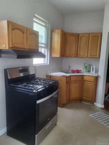 a kitchen with a sink stove and microwave