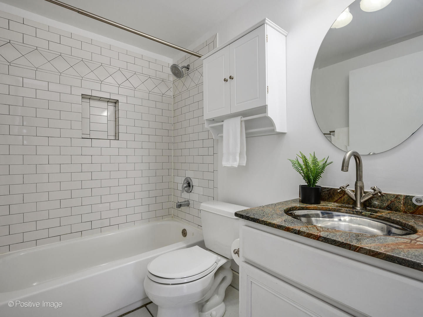 5 East 14th Place, Unit 501 Chicago, IL 60605 - Photo 17 of 26 a bathroom with a granite countertop sink a toilet and bathtub