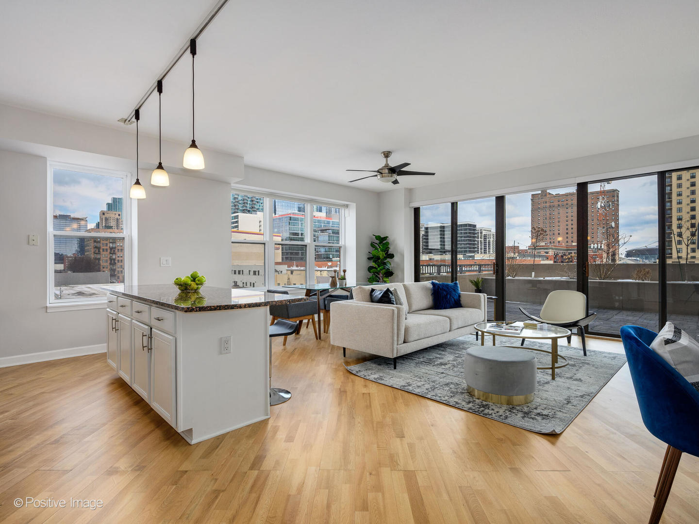 5 East 14th Place, Unit 501 Chicago, IL 60605 - Photo 2 of 26 a living room with kitchen island furniture and a chandelier