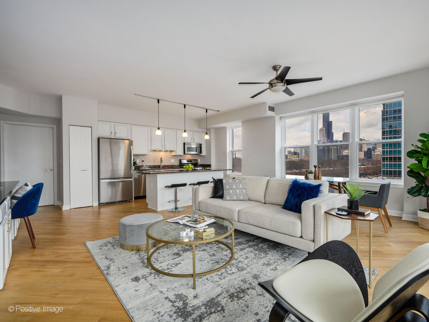 5 East 14th Place, Unit 501 Chicago, IL 60605 - Photo 9 of 26 a living room with furniture kitchen view and a chandelier