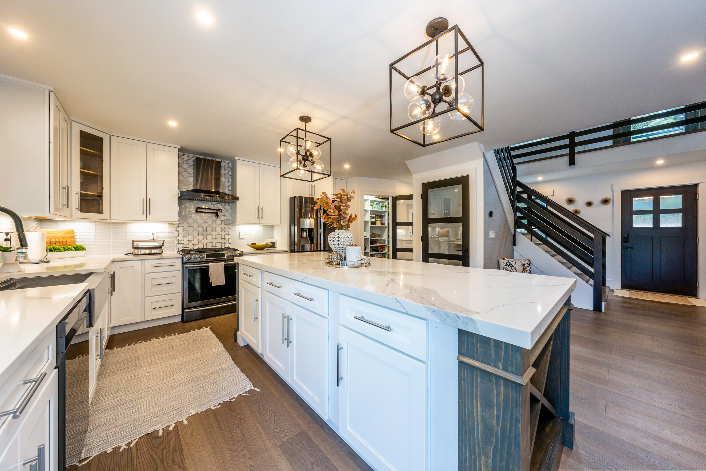 180 Kettle Hole Road West Barnstable, MA 02668 - Photo 5 of 53 a kitchen with cabinets a sink dishwasher a stove and a dining table with wooden floor