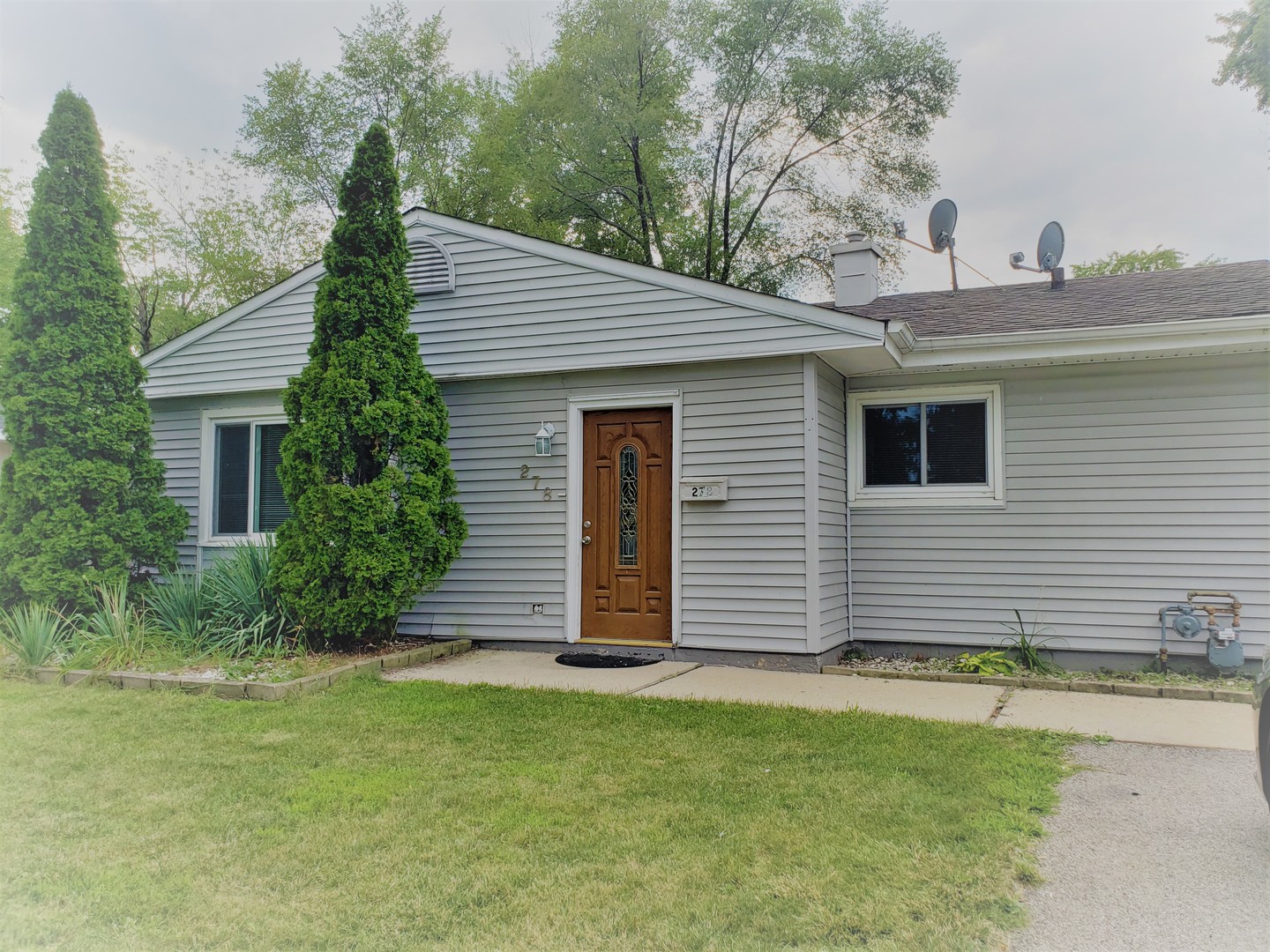278 Renee Terrace Wheeling, IL 60090 - Photo 1 of 11 a front view of a house with a garden