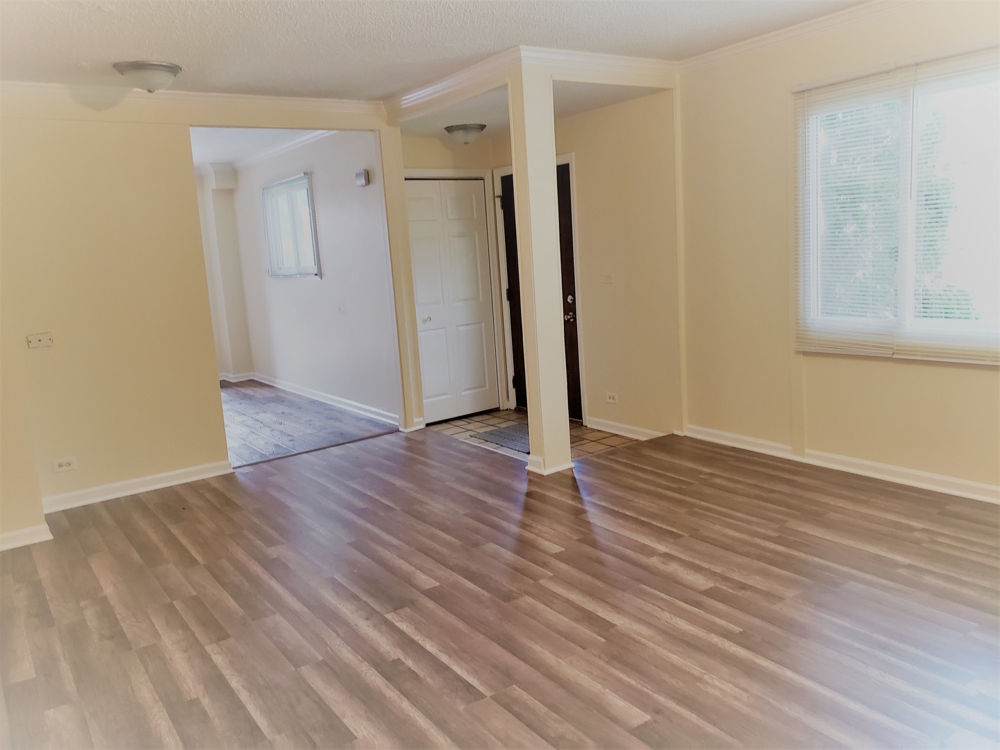278 Renee Terrace Wheeling, IL 60090 - Photo 2 of 11 a view of an empty room with wooden floor and a window
