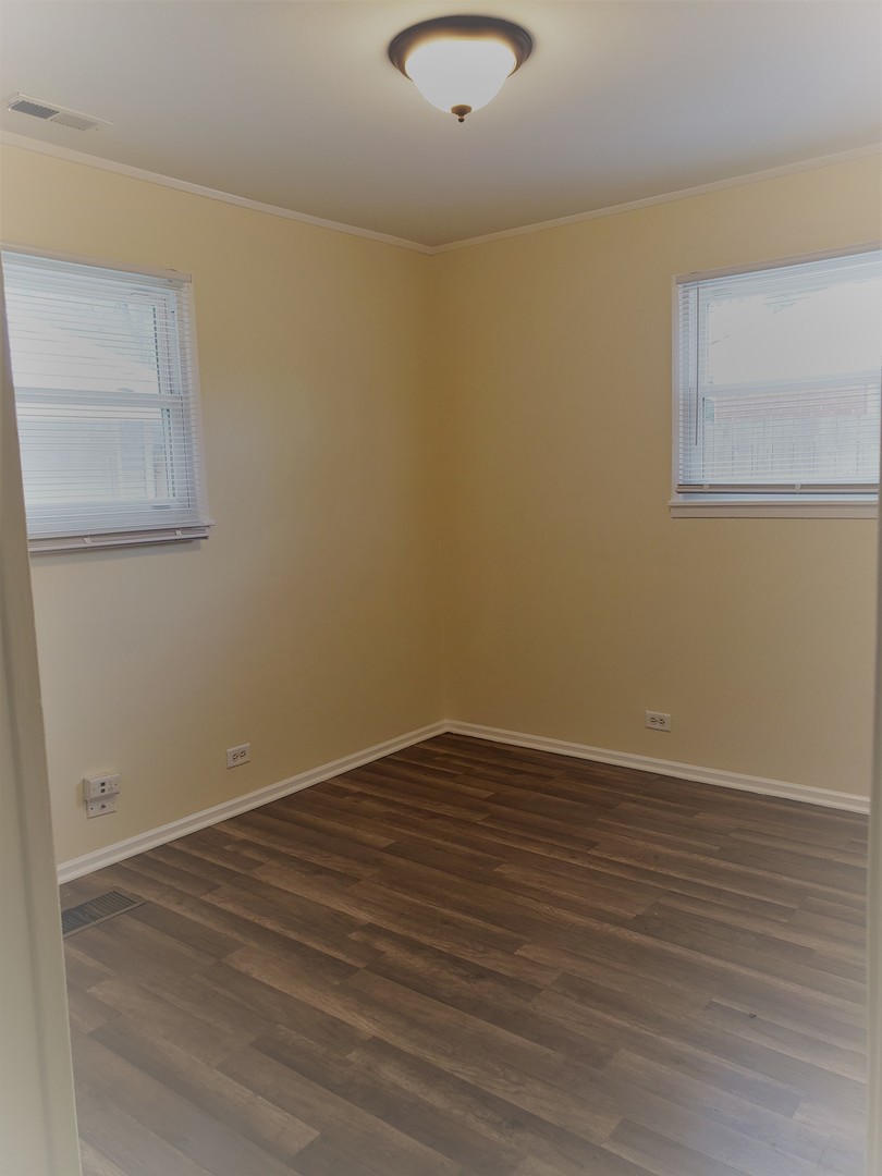 278 Renee Terrace Wheeling, IL 60090 - Photo 4 of 11 a view of an empty room with wooden floor and a window