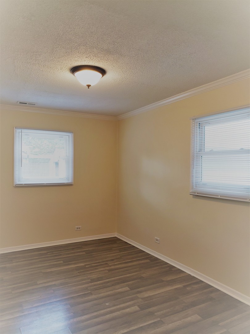 278 Renee Terrace Wheeling, IL 60090 - Photo 8 of 11 wooden floor in an empty room with a window