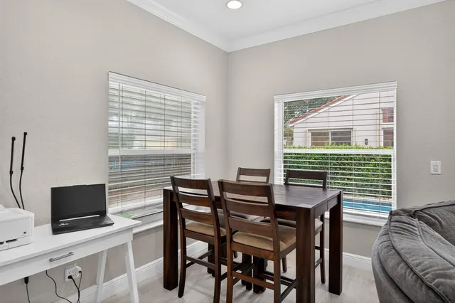 a view of a dining room with furniture and a flat screen tv