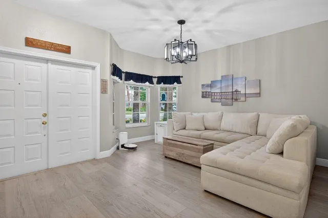 a living room with furniture and a chandelier