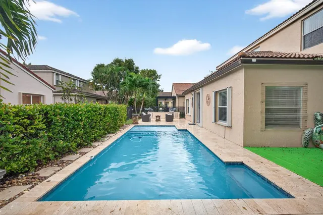 a view of house with yard and entertaining space