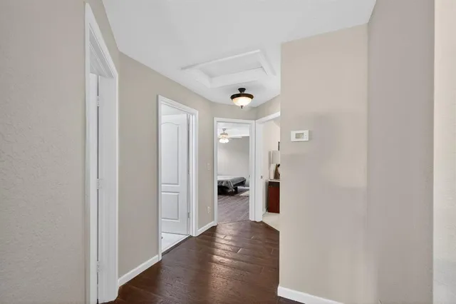 a view of a hallway with wooden shelves