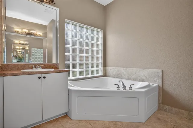 a bathroom with bathtub and window