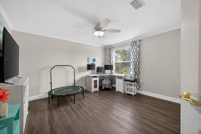 a living room with furniture a window and a flat screen tv