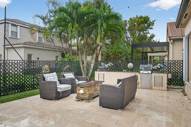 a view of a patio with couches and a fire pit