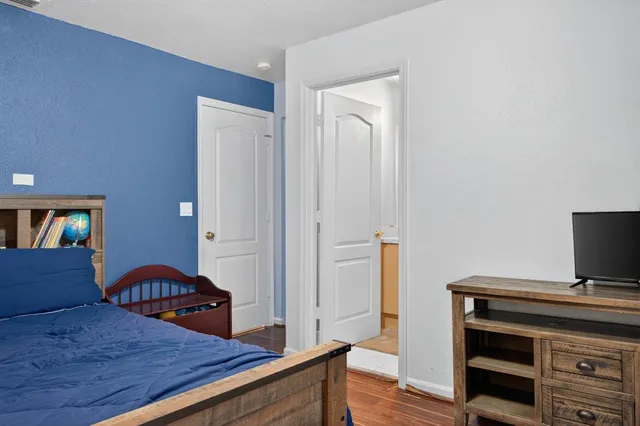 a bedroom with a bed and a dresser in it